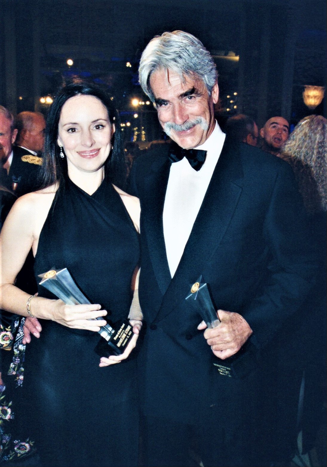 Sam Elliott and Madeleine Stowe holding awards